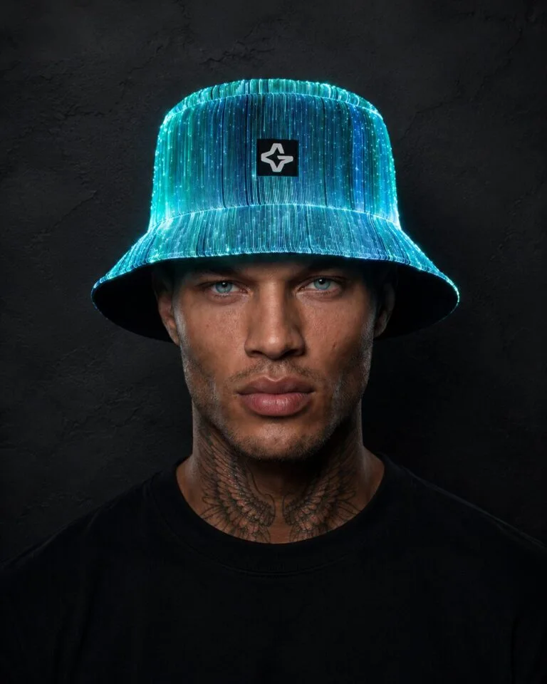 Man wearing a glowing LED bucket hat lit up in cyan and white