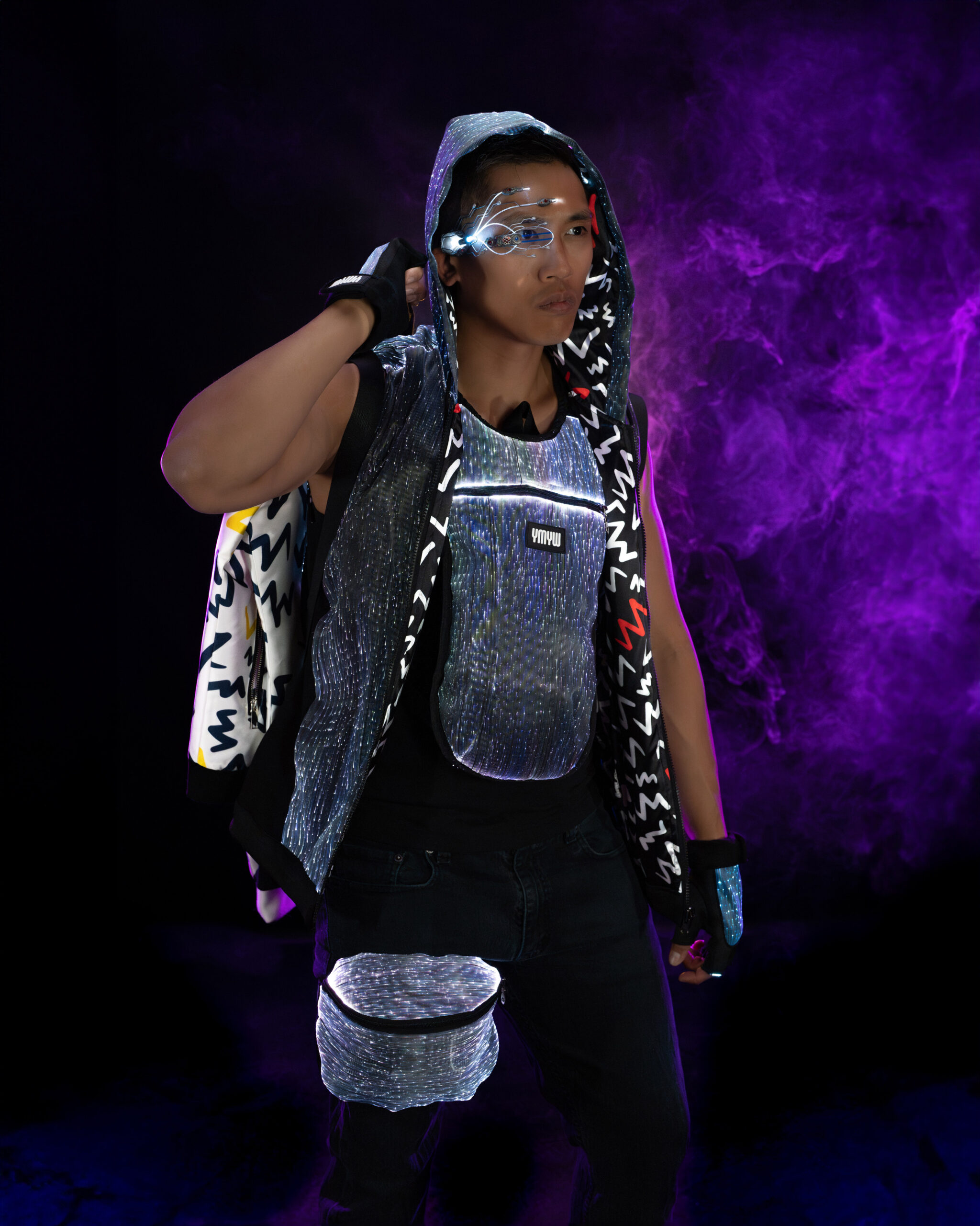 YMYW male model in full LED festival kit — Hood, Vest, Visor, Gloves, Fanny Pack — Electric Forest veteran loadout