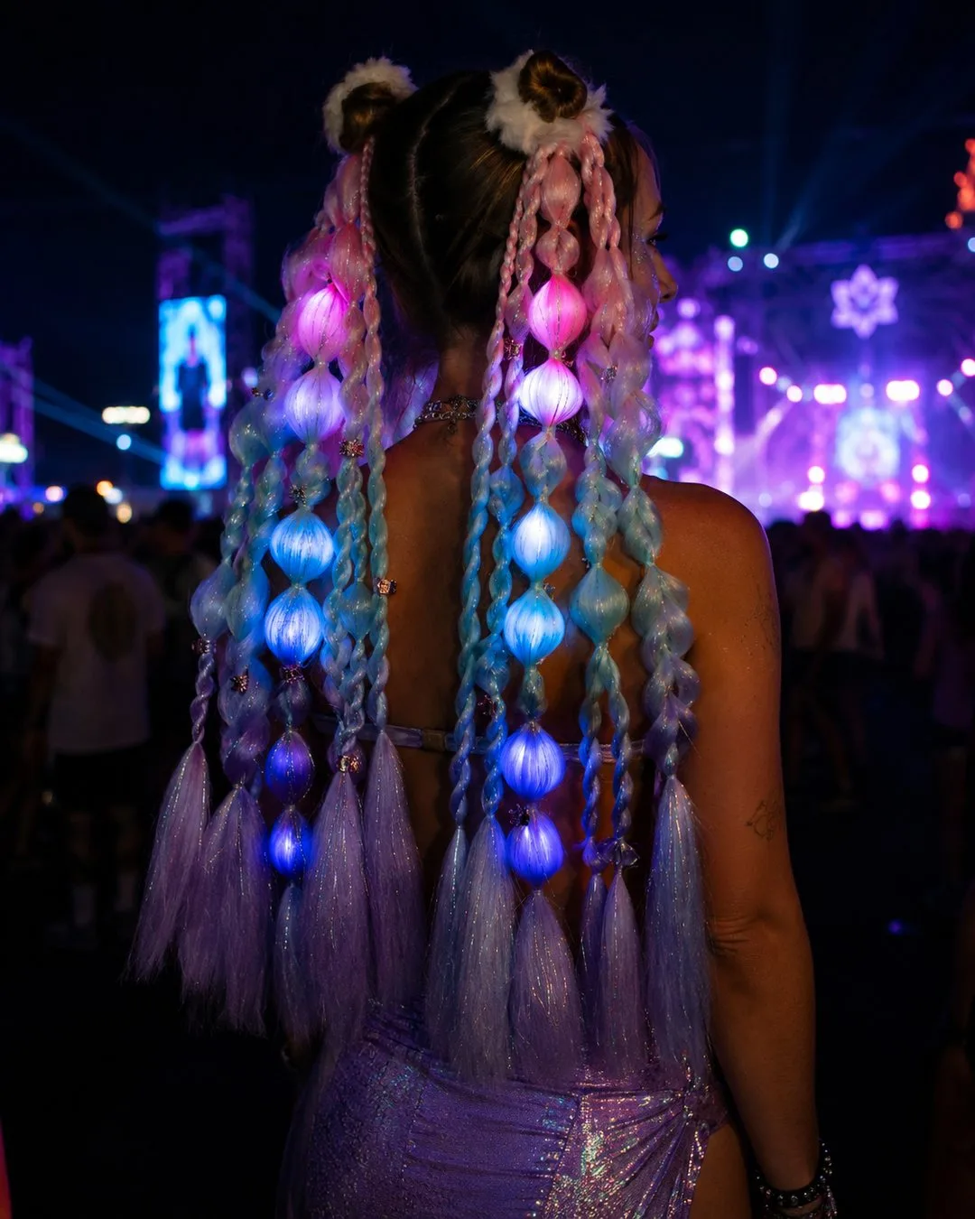 Light-up mermaid festival hair, glowing pink and aqua bubble-braid ponytail