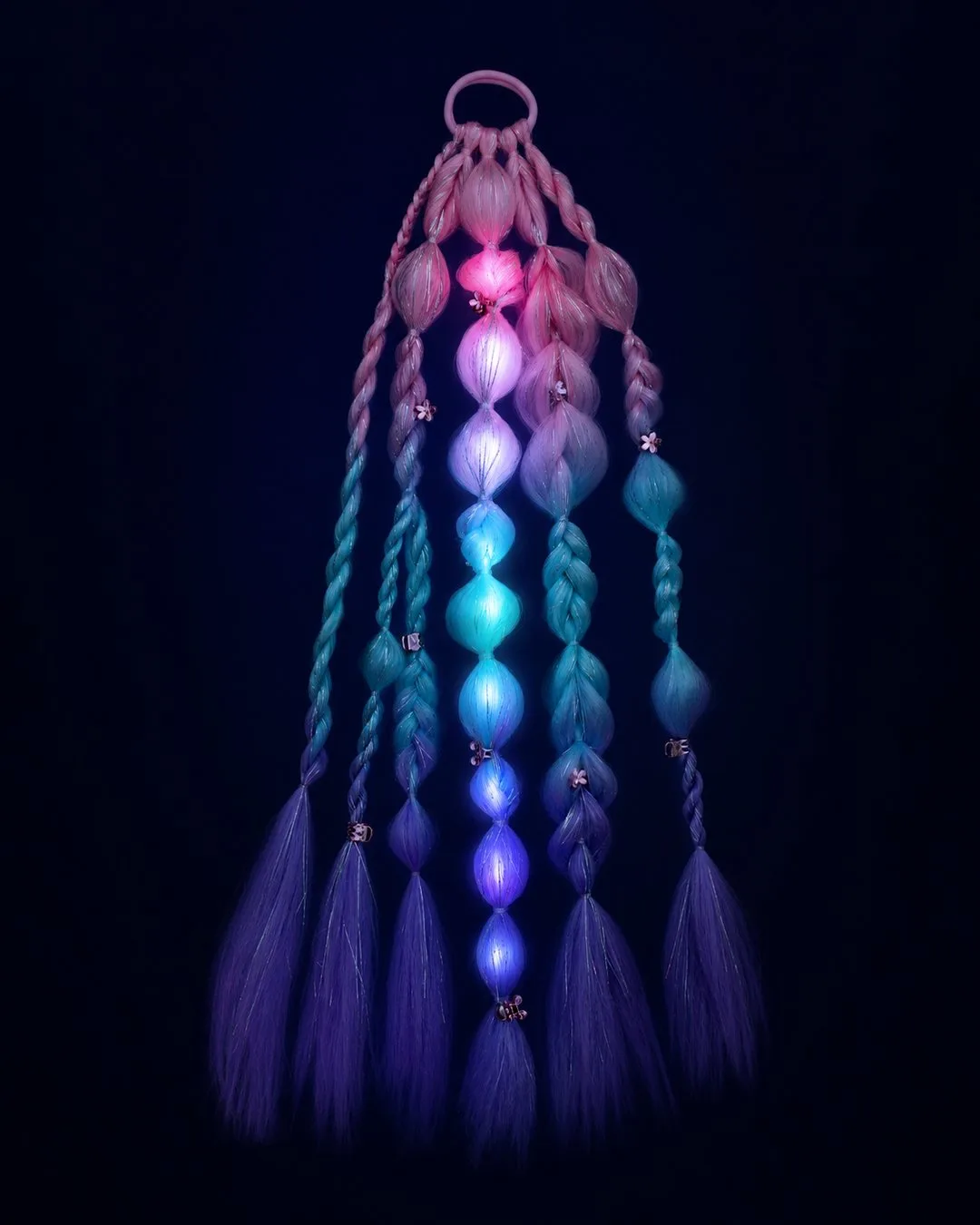 Rave fairy hair extensions glowing pink and aqua at night