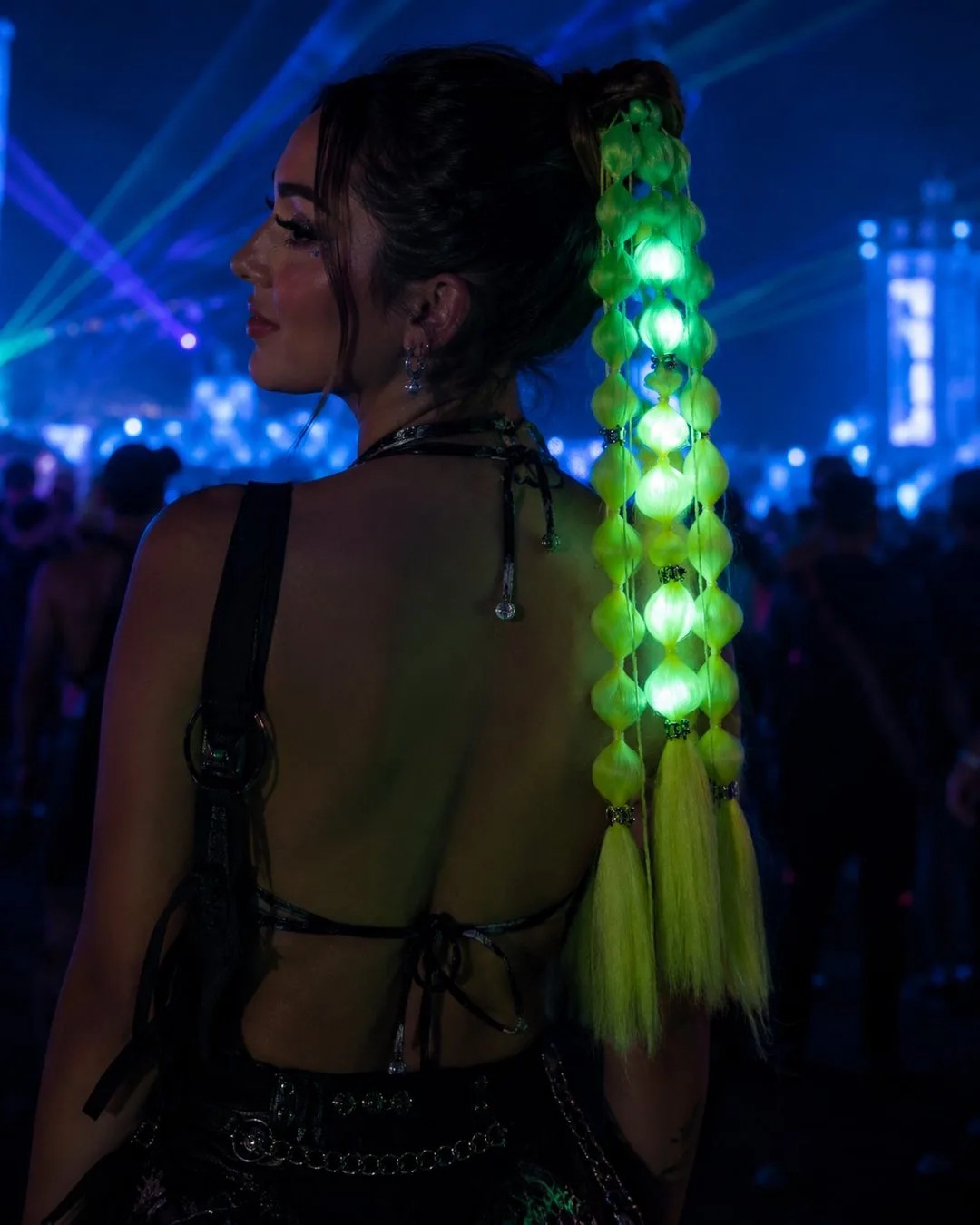 UV neon green LED hair extensions glowing bright at a rave