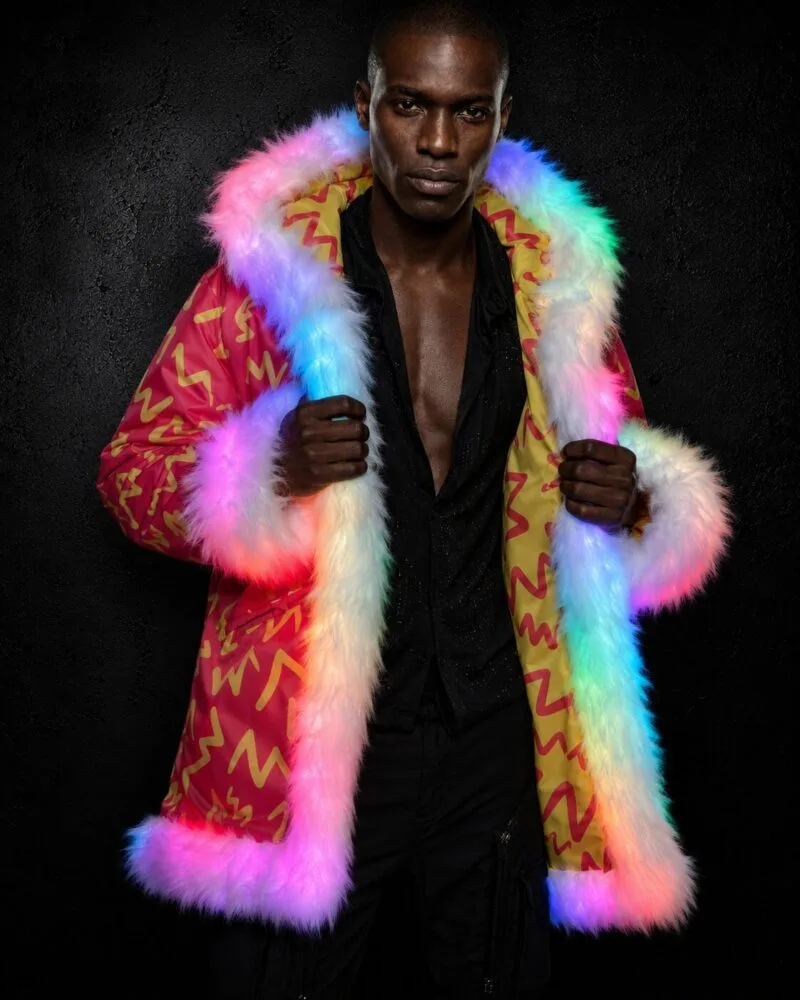 Man in a red and yellow LED fur coat with rainbow-glowing white fur trim, worn open