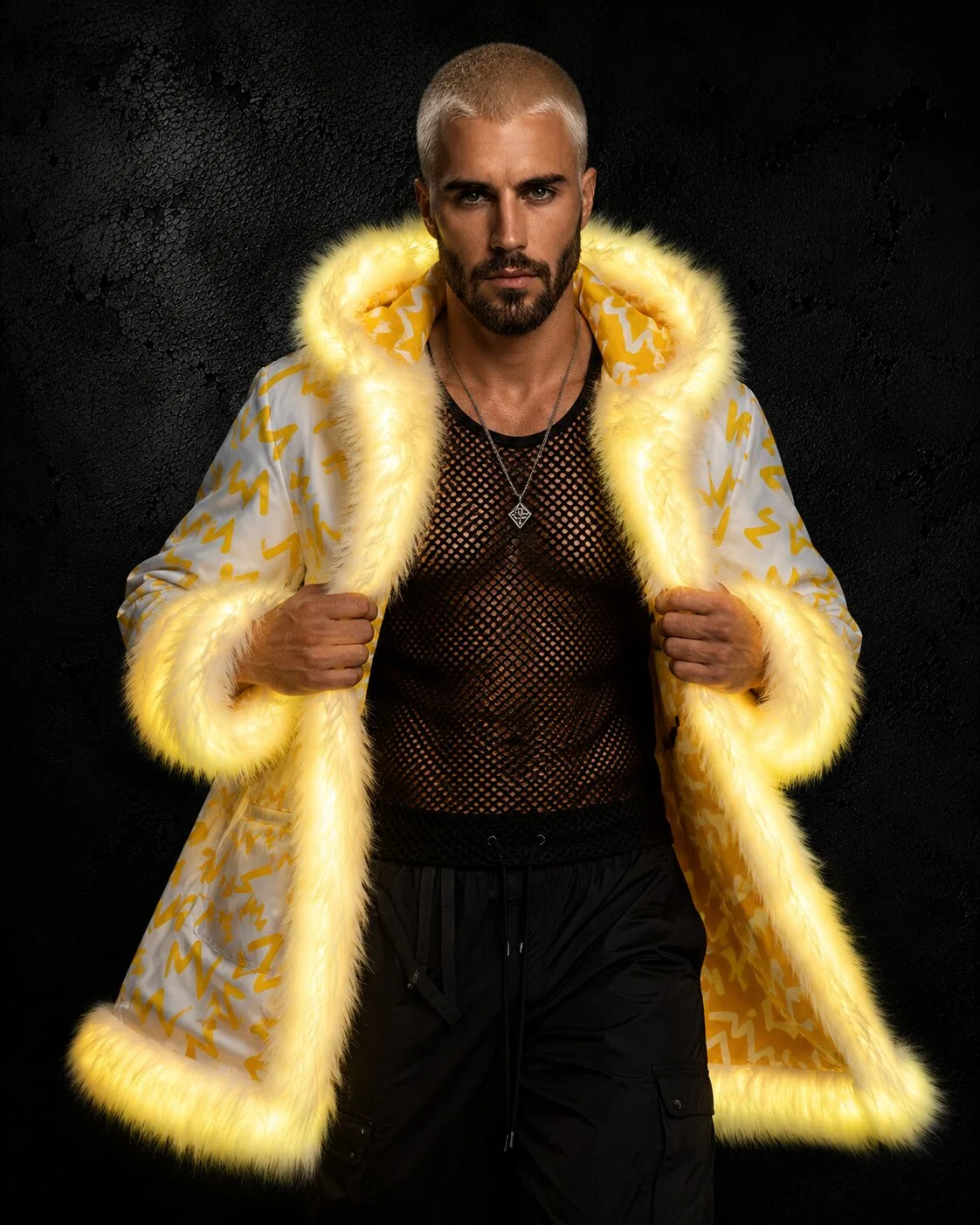 Man in a yellow and white LED fur coat with yellow-glowing white fur trim, full length