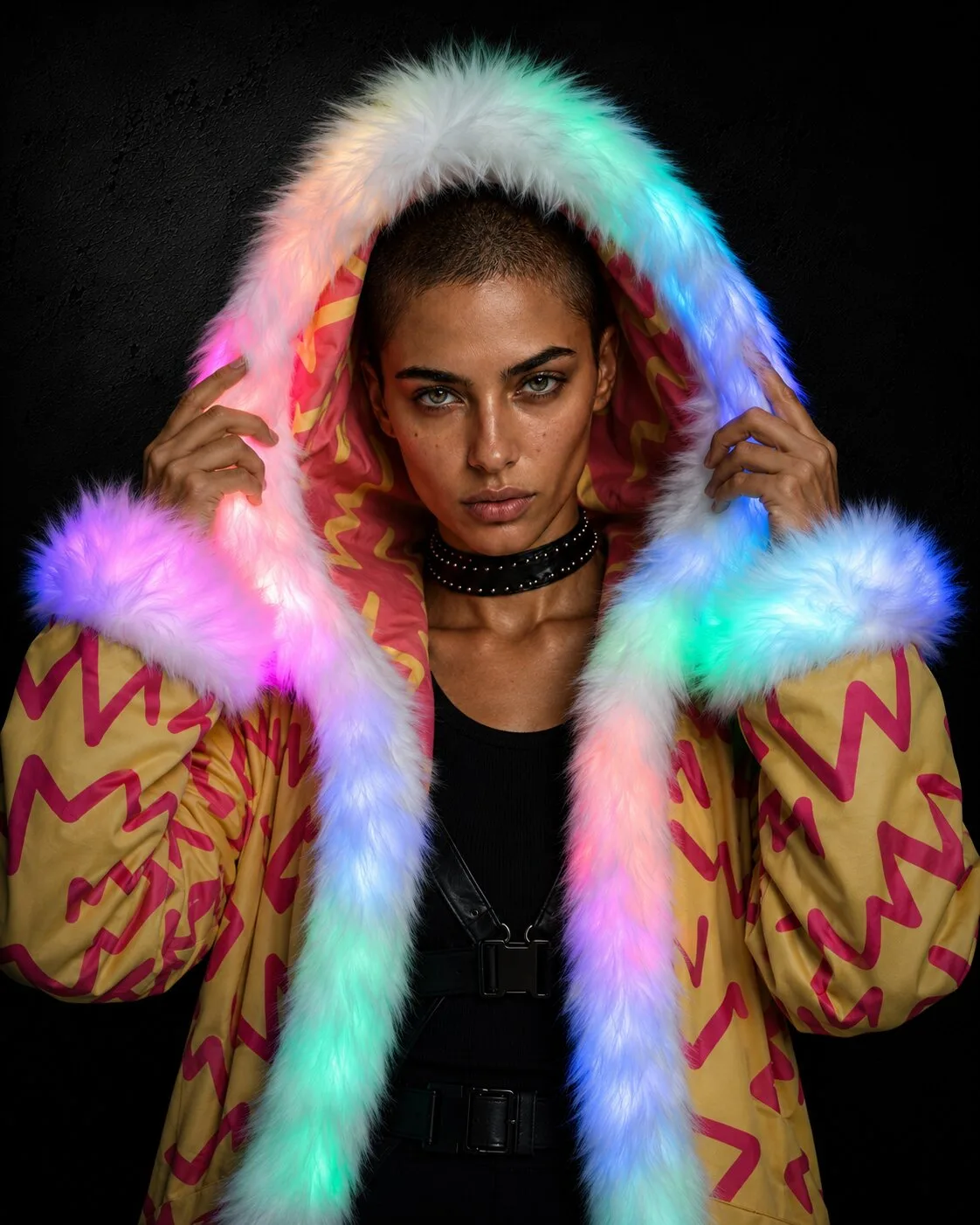 Woman in a red and yellow LED fur coat for Burning Man, glowing hood up