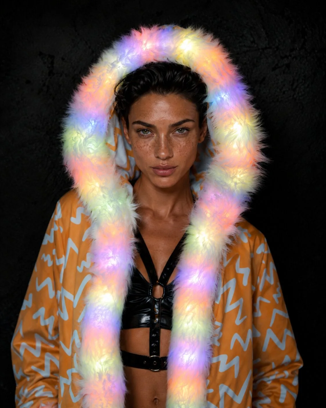 Woman in a light-up orange and white LED fur coat, glowing hood