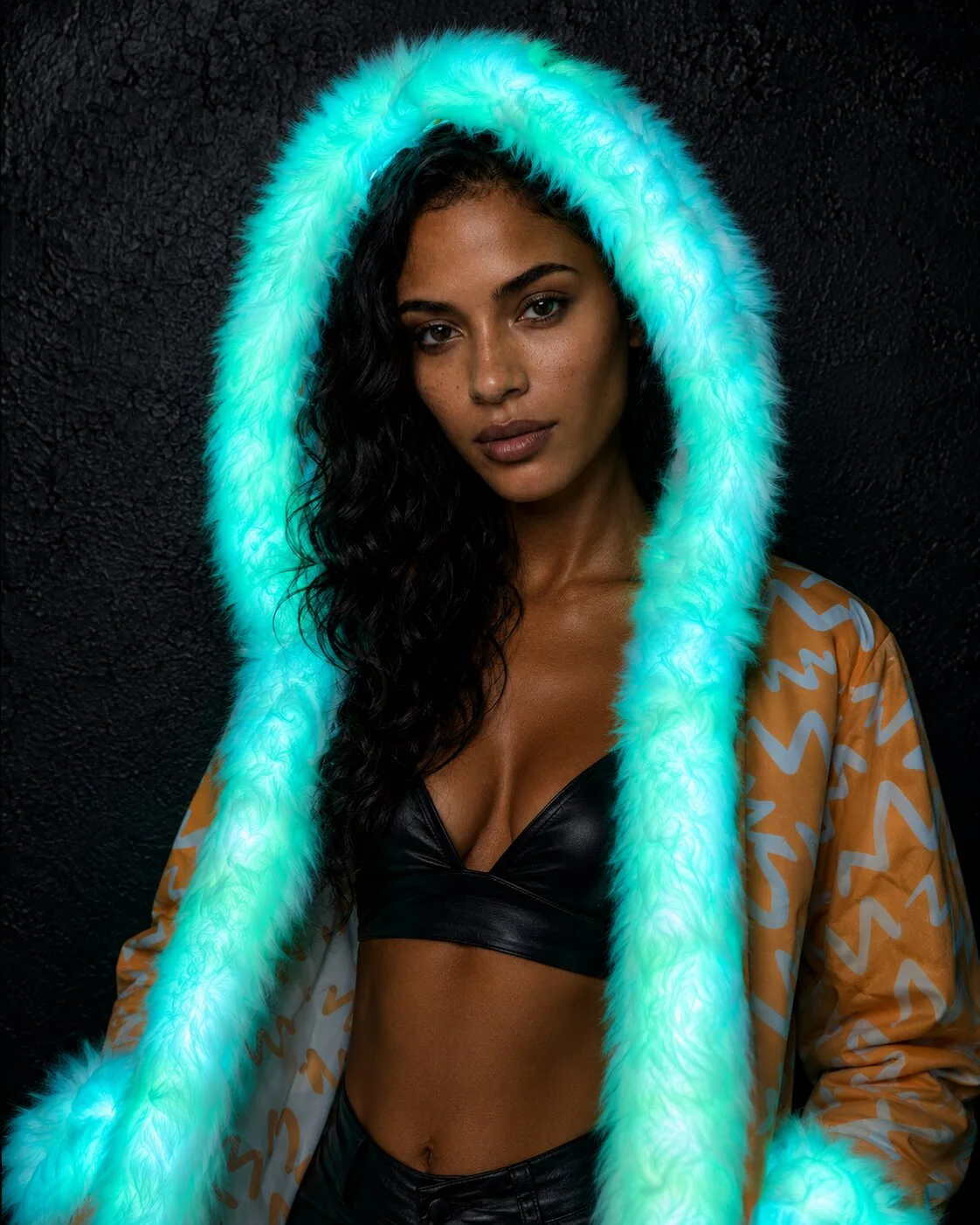 Woman in an orange and white LED fur coat glowing cyan